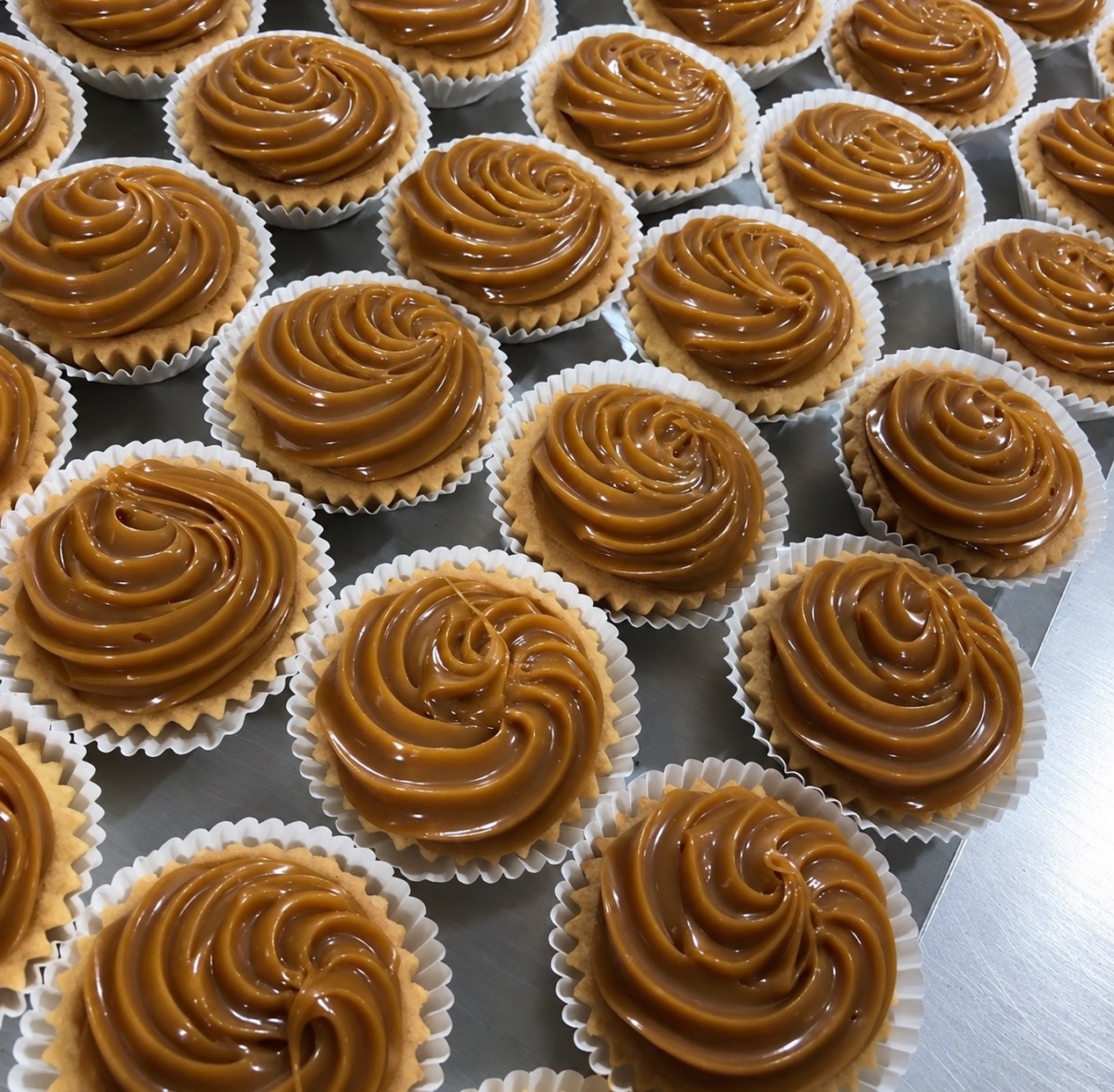 Bakery tarts with piped caramel filling