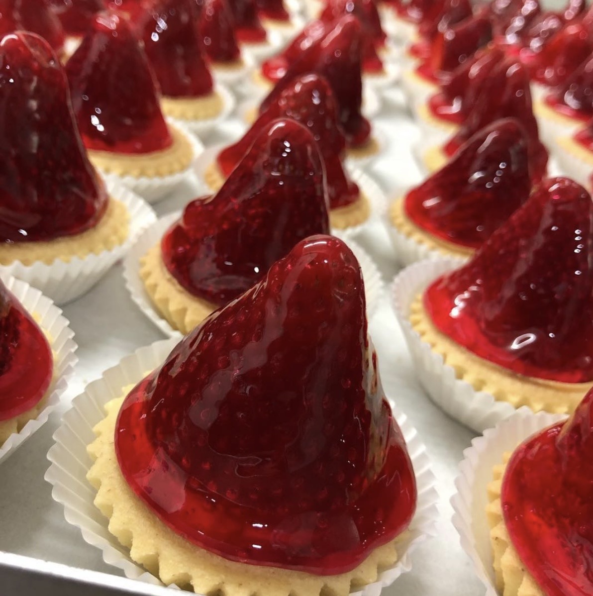 Red jelly-topped sweet treats on biscuit bases